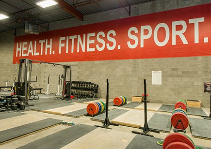 Exercise room with wall slogan: Health Fitness Sport