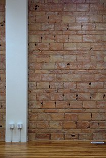 Exposed Brick wall with electrical outlet