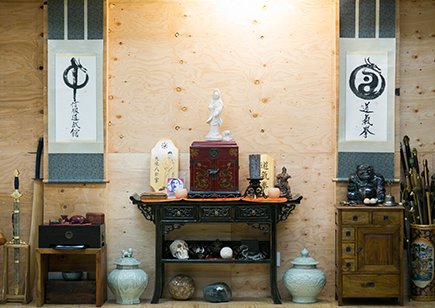 Shrine against plywood wall