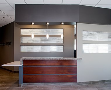 Reception with frosted glass windows and wood desk