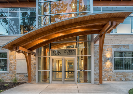 Curved Timber Beams with Metal Entrance Way